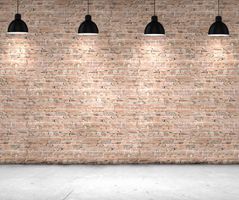 Blank brick wall with place for text illuminated by lamps above